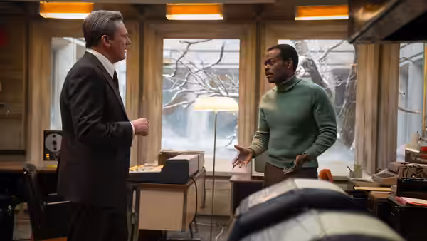 Fred Heckman (Jon Hamm) speaking with Ben Hairston (William Jackson Harper) in an office
