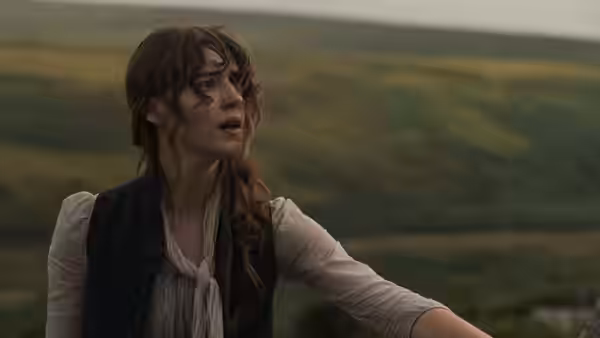Marianne Dashwood (Esmé Creed-Miles) reaches out across a grassy hillside