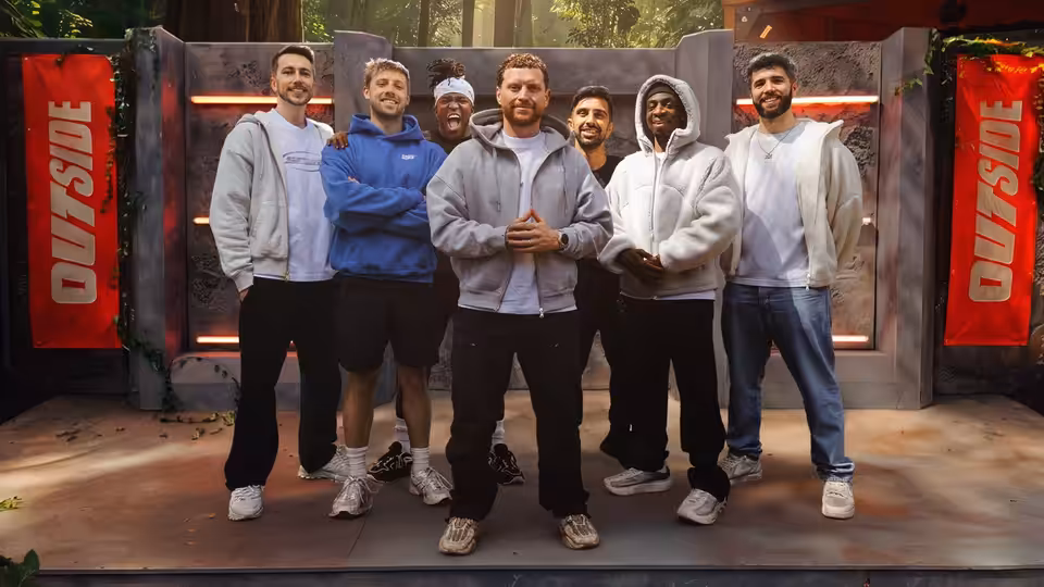 group of young men in hoodies and sweatpants posing together on a platform