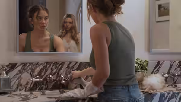 Millie Calloway (Sydney Sweeney) cleans a marble sink while Nina Winchester watches