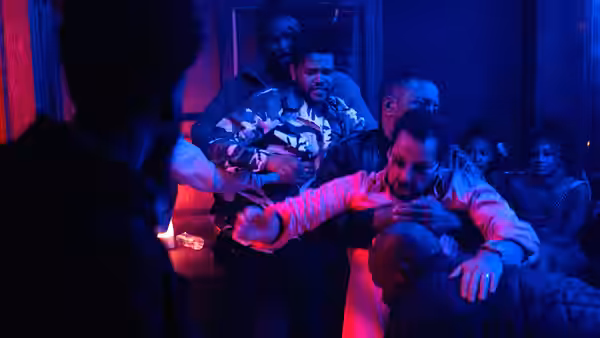 Demany (LaKeith Stanfield) held back during a fight in a dark room
