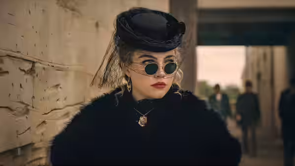 Cathy Ames (Florence Pugh) in a black hat and fur coat outside a building