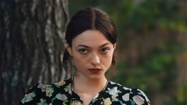 Cécile (Lily McInerny) looking forward with a serious expression