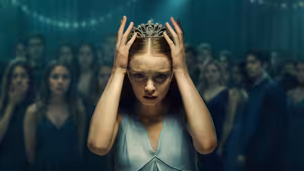 Carrie White (Summer H. Howell) clutching her head with a tiara at the prom