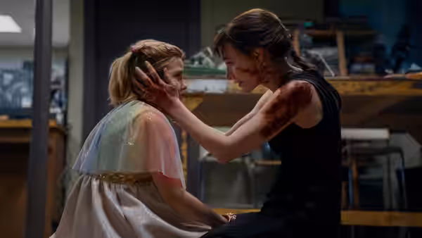 Ursula (Jessica Chastain) cups Bela’s face in a room
