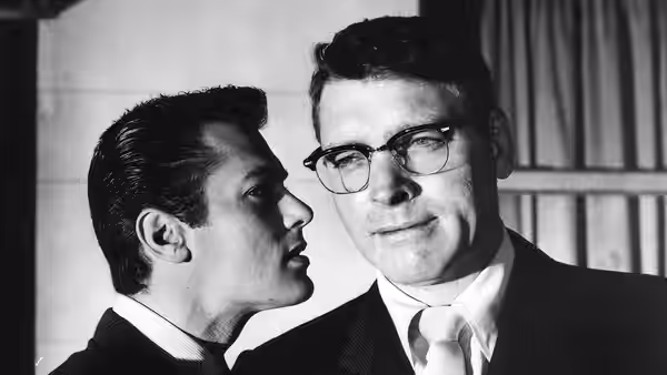 Sidney Falco (Tony Curtis) speaks close to J.J. Hunsecker (Burt Lancaster)