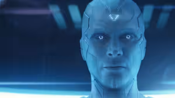Vision (Paul Bettany) faces forward in a blue-lit room, his eyes glowing