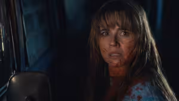 Pamela Voorhees (Linda Cardellini) sits bloodied inside a vehicle, staring ahead