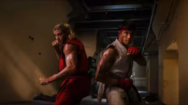 Ken and Ryu in fighting poses inside an industrial building