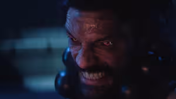 Akuma (Roman Reigns) bares his teeth, his eyes glowing red in the darkness