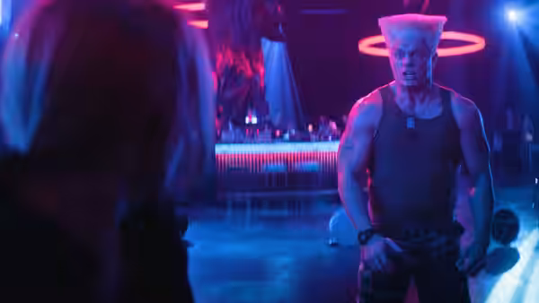 Guile (Cody Rhodes) faces a woman in a neon-lit nightclub