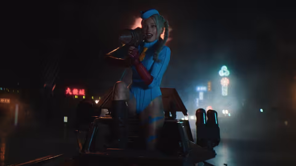 A woman in a blue bodysuit sits on a vehicle, holding a microphone beneath neon signs