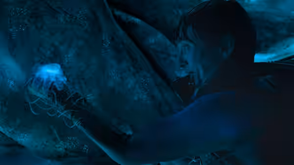 Jay Gardiner (Austin Abrams) reaches toward a glowing jellyfish beside a whale underwater