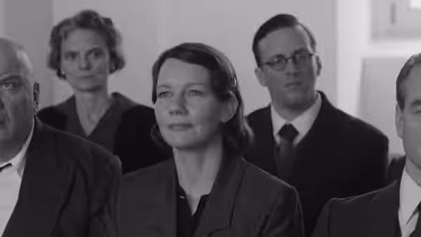 Erika Mann (Sandra Hüller) seated among attendees at a formal gathering