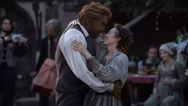 Fisherwoman (Olivia Colman) embraced by Wicker Husband (Alexander Skarsgård) in village square