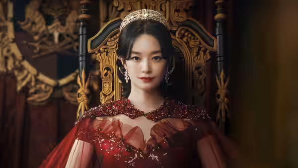 Navier (Shin Min-a) sits on an ornate throne in a jeweled red gown