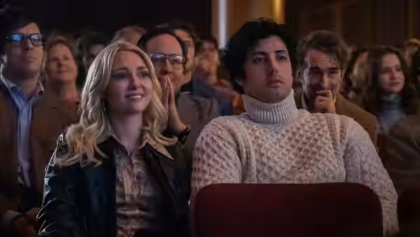 Sylvester Stallone (Anthony Ippolito) and Sasha Czack (AnnaSophia Robb) sit among an audience