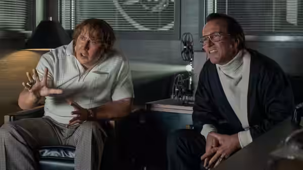 John Madden (Nicolas Cage) talks with Al Davis (Christian Bale) in an office