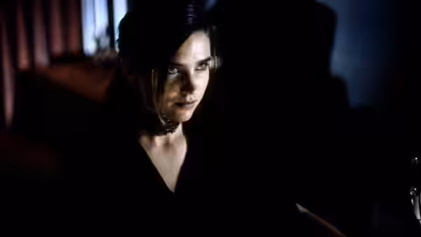 Marion Silver (Jennifer Connelly) looking to the side in dim light