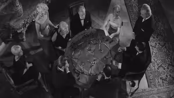 Hotel guests gather around a circular table for a game of matchsticks