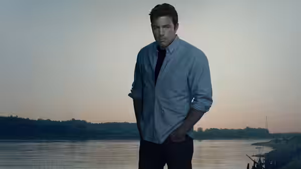 Nick Dunne (Ben Affleck) stands with hands in pockets by the water