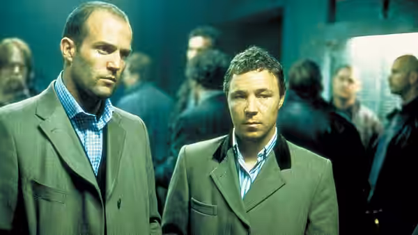 Turkish (Jason Statham) and Tommy (Stephen Graham) standing in a room