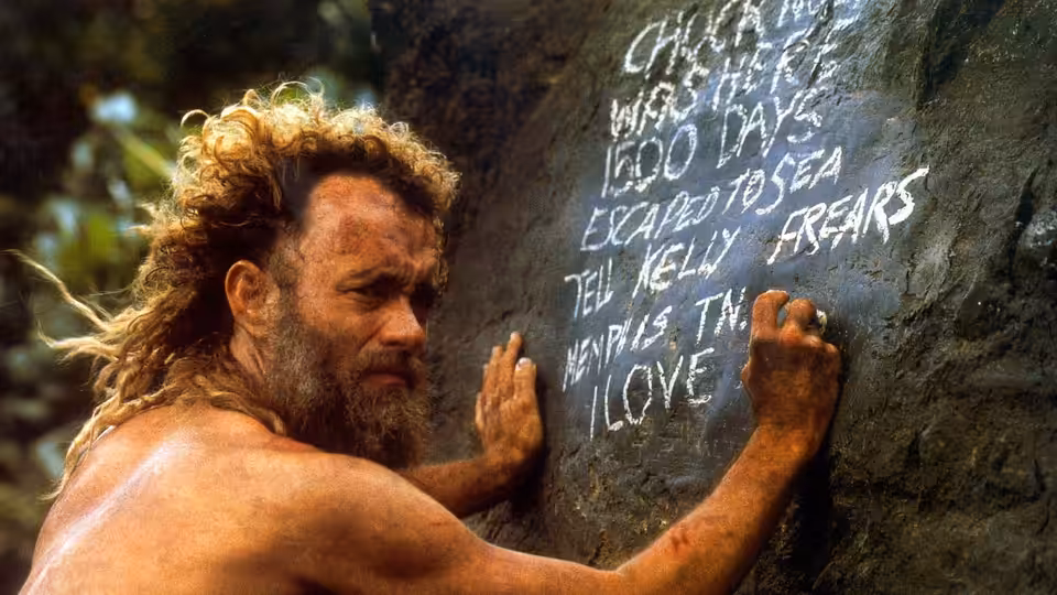 Chuck Noland (Tom Hanks) carving a message on a large rock