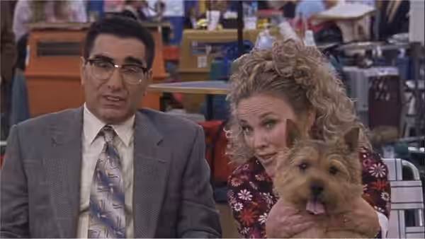 Dr. Millbank (Bob Balaban) and Sherri Ann Cabot (Jennifer Coolidge) hold a terrier at the show