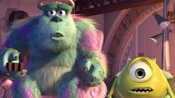 Sullivan and Mike sit together looking ahead with wide eyes