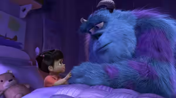 Sullivan sits on a bed facing Boo in a child's bedroom