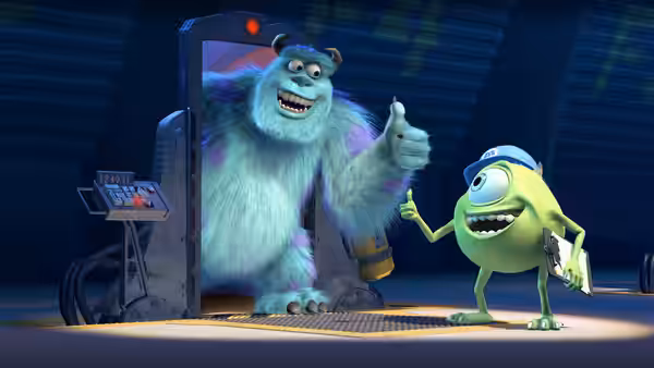 Sullivan gives a thumbs up beside Mike at a factory door