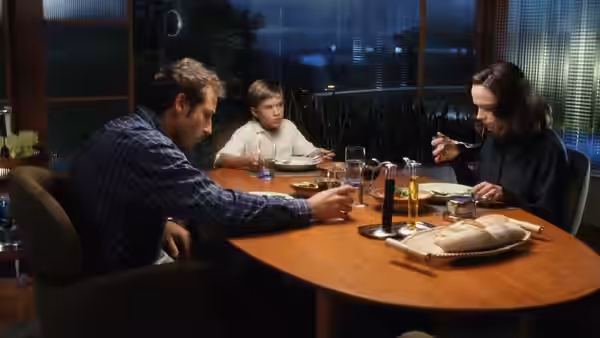 Henry (Sam Robards) Martin (Jake Thomas) and Monica (Frances O'Connor) seated at the dinner table