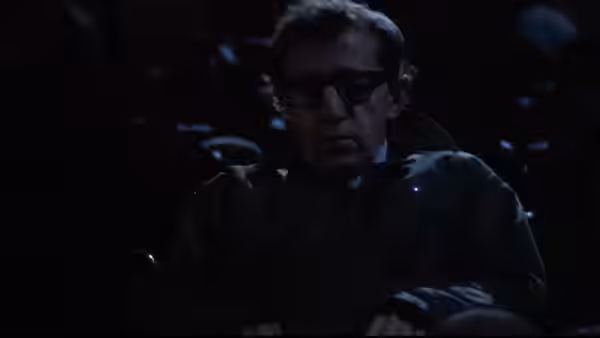 Mickey Sachs (Woody Allen) seated in a darkened theater