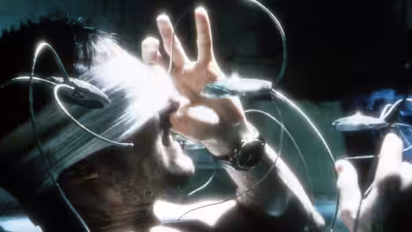 Chief John Anderton (Tom Cruise) extending his hand with neural headgear on
