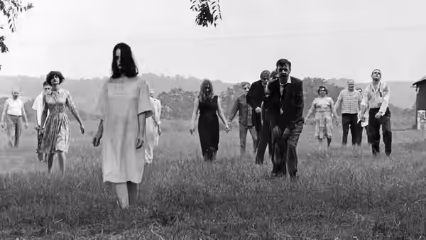 A group of zombies advances across an open field