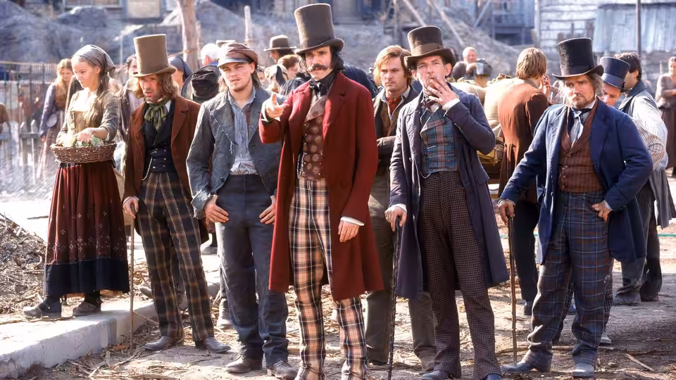 Bill 'The Butcher' Cutting (Daniel Day-Lewis) gesturing among men in period attire outdoors
