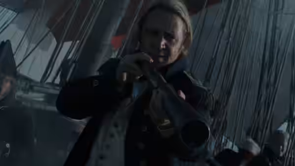 Captain Jack Aubrey (Russell Crowe) peering through a telescope on the ship's deck