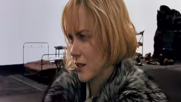 Nicole Kidman with short blonde hair in a fur coat outdoors