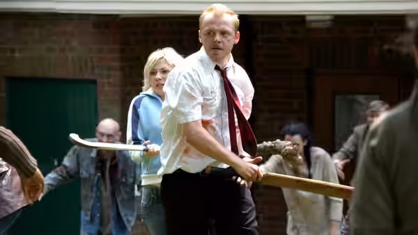 Shaun (Simon Pegg) gripping a cricket bat as zombies close in around him