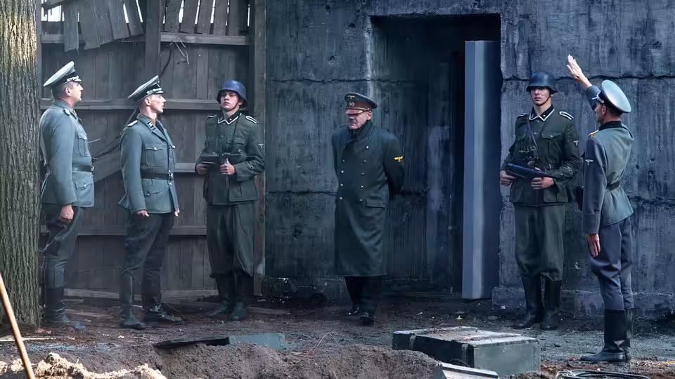 Group of German officers gathered outside a concrete bunker entrance