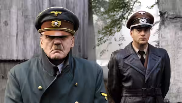 Adolf Hitler (Bruno Ganz) standing beside an officer near ruins