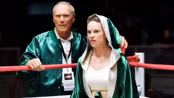 Frankie Dunn (Clint Eastwood) stands behind Maggie Fitzgerald (Hilary Swank) in the boxing ring