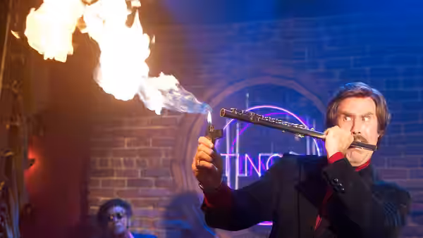 Ron Burgundy (Will Ferrell) playing a flute that shoots fire indoors