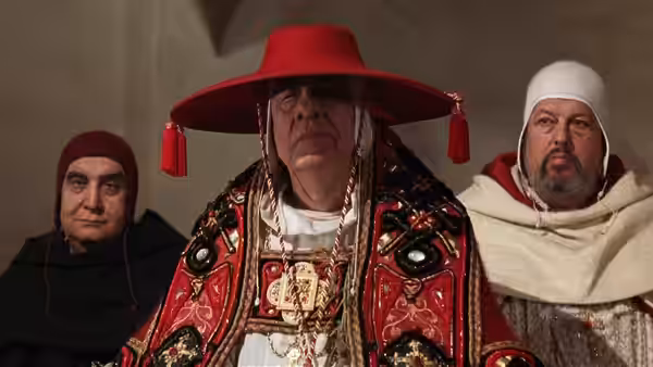 The Abbot (Michael Lonsdale) stands between two monks in ceremonial robes