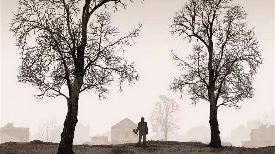 a man standing between two leafless trees on a foggy hill