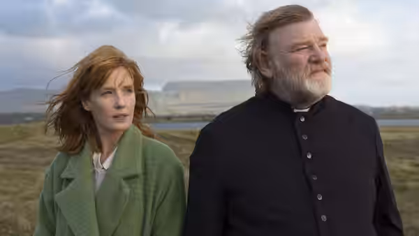 Father James (Brendan Gleeson) and Fiona (Kelly Reilly) in a windy field
