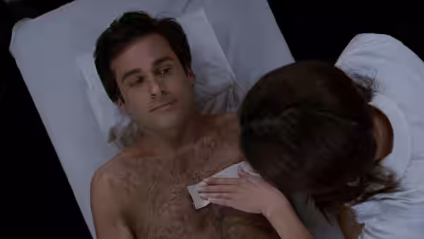 Andy Stitzer (Steve Carell) lies in bed as a woman wipes his chest