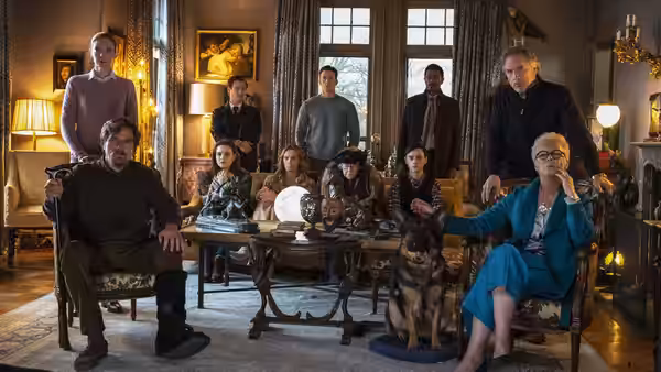 The Thrombey family gathered around a table in the living room
