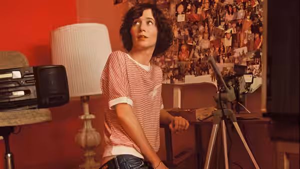 Christine (Miranda July) looking up in her bedroom beside a tripod