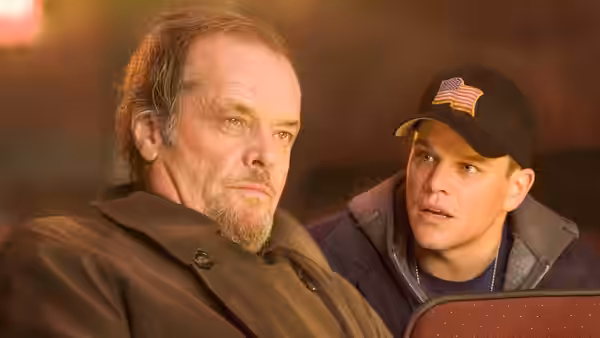 Costello (Jack Nicholson) sitting beside Colin (Matt Damon) in a vehicle